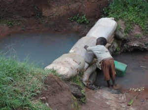 Boy getting drinking water in Kenya